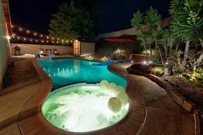 a swimming pool in a backyard at night at San Diego 4-Bedroom Home with POOL and Jacuzzi in Rancho Bernardo