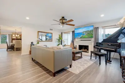 a living room with a couch and a piano at San Diego 4-Bedroom Home with POOL and Jacuzzi in Rancho Bernardo