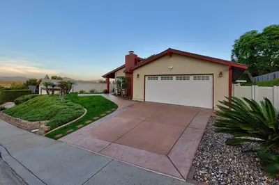 a house with a driveway and a garage at San Diego 4-Bedroom Home with POOL and Jacuzzi in Rancho Bernardo