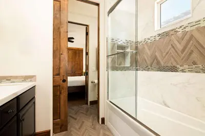 a bathroom with a shower with a glass door at Coastal Oasis Walk to Ocean Bay and Rooftop Deck in San Diego