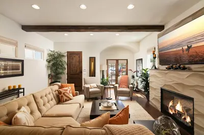 a living room with a couch and a fireplace at Coastal Oasis Walk to Ocean Bay and Rooftop Deck in San Diego