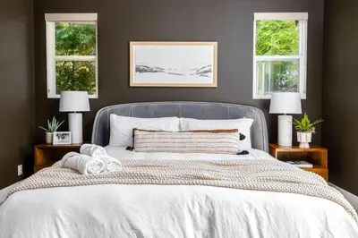 a bedroom with a large white bed with two windows at Gated Home With Pool & Hot Tub in Vista