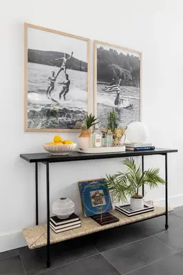 a black shelf in a room with pictures on the wall at Gated Home With Pool & Hot Tub in Vista