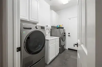 a laundry room with a washing machine and a washer at Gated Home With Pool & Hot Tub in Vista