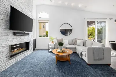 a living room with a couch and a fireplace at Gated Home With Pool & Hot Tub in Vista