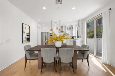 a kitchen and dining room with a wooden table and chairs at #Marbella Lane - Curated 5BR in Upscale RMV Haven in Ladera Ranch
