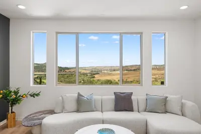 a living room with a couch and four windows at #Marbella Lane - Curated 5BR in Upscale RMV Haven in Ladera Ranch
