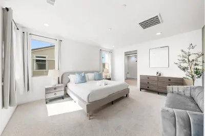 a white bedroom with a bed and a couch at #Marbella Lane - Curated 5BR in Upscale RMV Haven in Ladera Ranch
