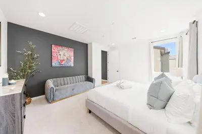 a bedroom with a white bed and a couch at #Marbella Lane - Curated 5BR in Upscale RMV Haven in Ladera Ranch