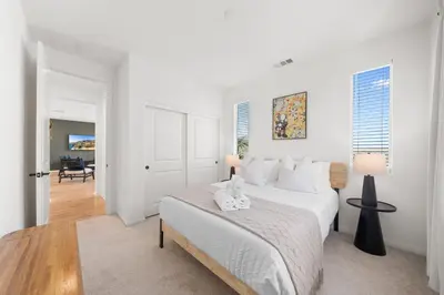a white bedroom with a bed and a lamp at #Marbella Lane - Curated 5BR in Upscale RMV Haven in Ladera Ranch