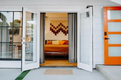 an open door leading to a bedroom with a bed at Private Pool Chefs Kitchen BBQ 4min to SDSU in La Mesa