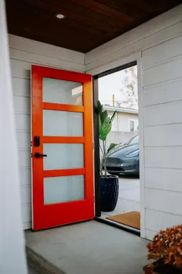 an orange door on the side of a house at Private Pool Chefs Kitchen BBQ 4min to SDSU in La Mesa