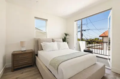 a bedroom with a bed and a large window at Ocean Beach Getaway with Peek Views in San Diego