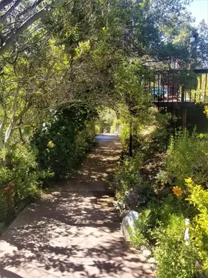 a path through a garden with an archway at La Casita Private Resort Spa and Mini Golf Course in Alpine