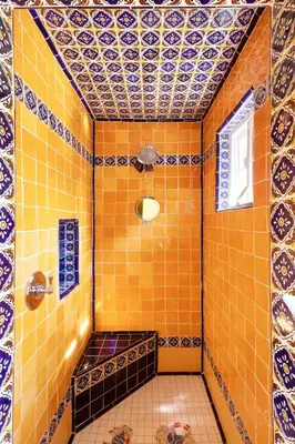 a bathroom with orange tiled walls and a shower at La Casita Private Resort Spa and Mini Golf Course in Alpine