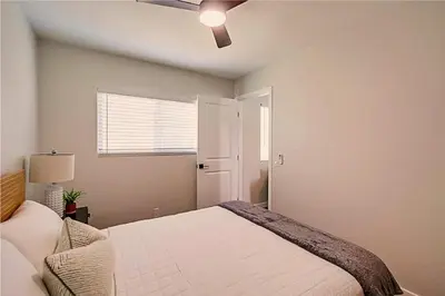 a bedroom with a bed and a ceiling fan at Stylish 1BR Near Downtown, Beaches & North Park in San Diego