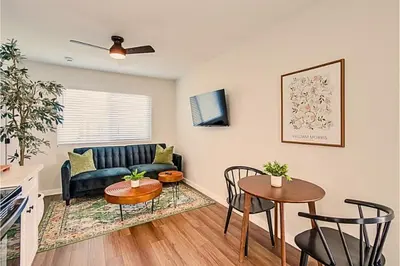 a living room with a couch and a table at Stylish 1BR Near Downtown, Beaches & North Park in San Diego