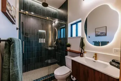 a bathroom with a shower and a toilet and a sink at Central SD, Luxury Home and Casita, Pool, BBQ, Sleeps10 in La Mesa