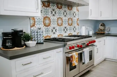 a kitchen with white cabinets and a stove top oven at Central SD, Luxury Home and Casita, Pool, BBQ, Sleeps10 in La Mesa
