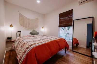 a bedroom with a bed and a large window at Central SD, Luxury Home and Casita, Pool, BBQ, Sleeps10 in La Mesa