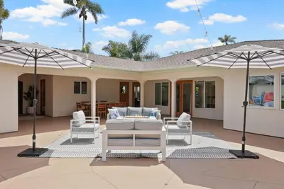a house with two umbrellas on a patio at Stunning La Jolla Hideaway Close to Everything in San Diego