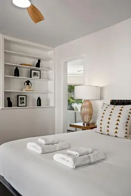 a white bedroom with two towels on a bed at Stunning La Jolla Hideaway Close to Everything in San Diego