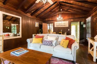 a living room with a couch and a table at Redwood Hollow Cottages in San Diego