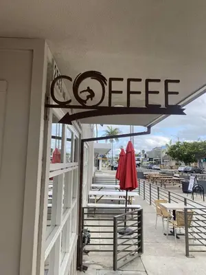 a restaurant with an open sign on the side of a building at Beach Oasis in Carlsbad Village in Carlsbad