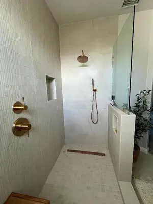 a bathroom with a shower with a toilet and a sink at Beach Oasis in Carlsbad Village in Carlsbad