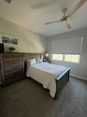 a bedroom with a bed with a dresser and a window at Beach Oasis in Carlsbad Village in Carlsbad