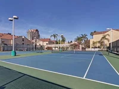 a tennis court with two tennis nets on it at --Vacation First floor luxury condo La Jolla, Spa, Pool, Gym in San Diego