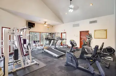 a gym with several treadmills and cardio machines at --Vacation First floor luxury condo La Jolla, Spa, Pool, Gym in San Diego