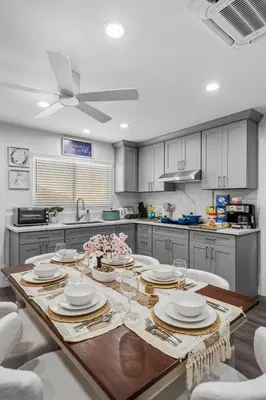 a kitchen with a table with plates and dishes on it at Entire Private Home with 3 Bedrooms 3 Bathrooms, House with Yard, King Bed, Prime Location, Available Now in San Diego
