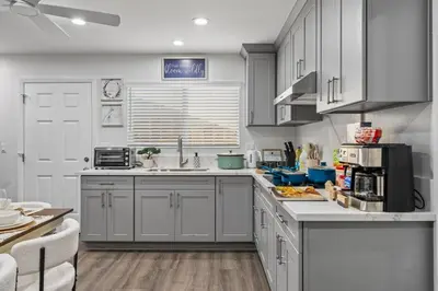 a kitchen with white cabinets and a counter top at Entire Private Home with 3 Bedrooms 3 Bathrooms, House with Yard, King Bed, Prime Location, Available Now in San Diego