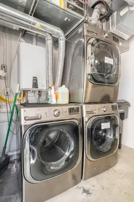 a laundry room with three washing machines and a washer and dryer at Modern Surf Themed Home - Heart of Gaslamp in San Diego