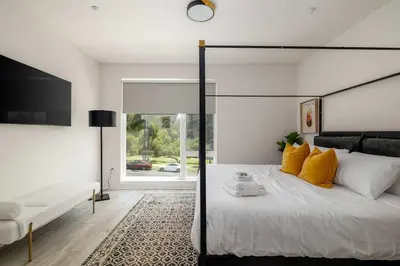 a bedroom with a large bed with yellow pillows at NEW 3br Luxury Townhome - Gaslamp - Balboa Park in San Diego