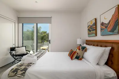 a bedroom with a large white bed and a balcony at NEW 3br Luxury Townhome - Gaslamp - Balboa Park in San Diego