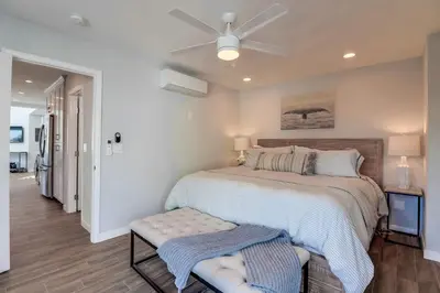 a bedroom with a bed and a ceiling fan at Steps to Bay & Beach, Rooftop Deck, Fire Pit, AC, Garage, Views in San Diego