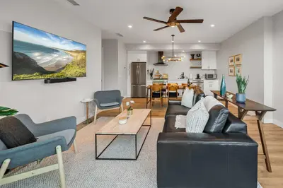 a living room with a couch and a dining room at Del Mar Retreat - Laundry BBQ Firepit AC Patio in San Diego