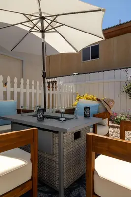 a table with an umbrella on a patio at Chic Beach Retreat - Newly Furnished 1BR in Ocean Beach! in San Diego