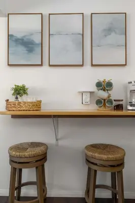 a counter with two stools in a room at Chic Beach Retreat - Newly Furnished 1BR in Ocean Beach! in San Diego