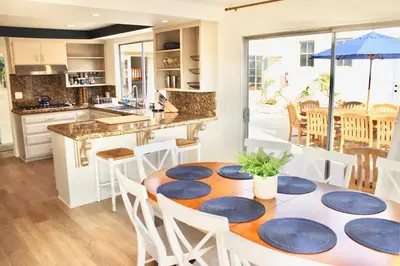 a kitchen and dining room with a table and chairs at Saint Ann's Court in Laguna Beach