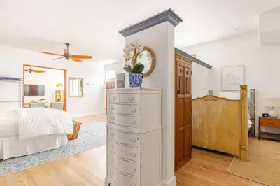 a bedroom with a bed and a dresser in a room at Saint Ann's Court in Laguna Beach