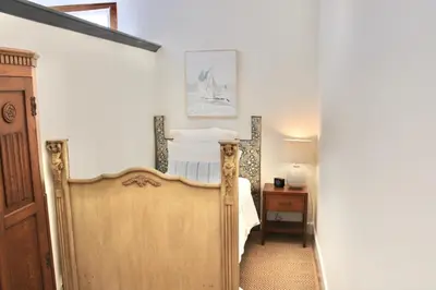 a bedroom with a bed and a mirror at Saint Ann's Court in Laguna Beach