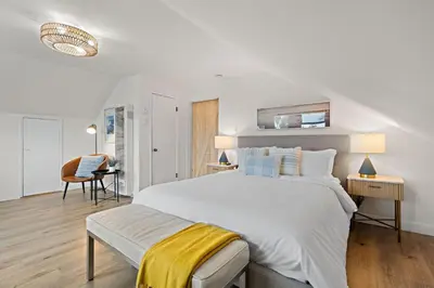 a white bedroom with a large bed with a yellow blanket at Ocean-View, Deck, Steps to Beach Dining and More in Solana Beach