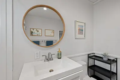 a white bathroom with a sink and a mirror at Ocean-View, Deck, Steps to Beach Dining and More in Solana Beach