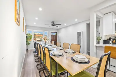 a dining room with a long table and chairs at Bay Park Bliss Ocean Views Pickleball and Jacuzzi in San Diego