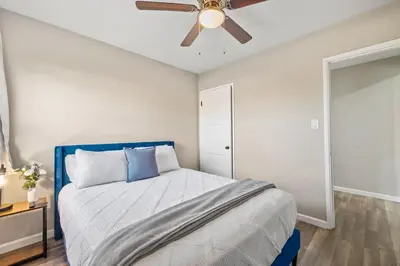a bedroom with a bed and a ceiling fan at Bay Park Bliss Ocean Views Pickleball and Jacuzzi in San Diego