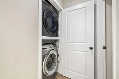 a laundry room with a washer and dryer at Bay Park Bliss Ocean Views Pickleball and Jacuzzi in San Diego