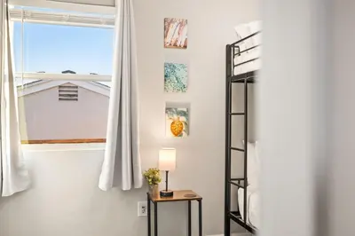a room with a ladder and a table and a window at Bay Park Bliss Ocean Views Pickleball and Jacuzzi in San Diego